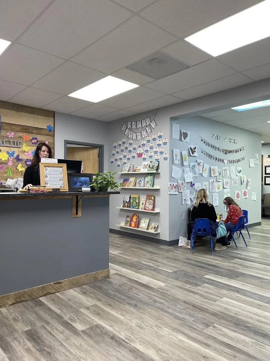 Children playing in family-friendly waiting room for childhood anxiety chiropractic care in Liberty MO