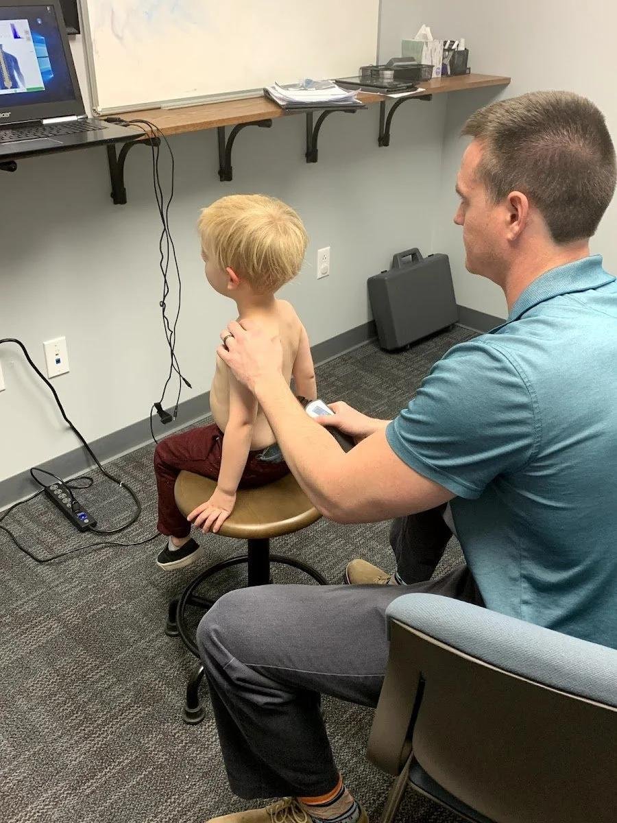 CLA INSiGHT scan on seated boy for families from Excelsior Springs