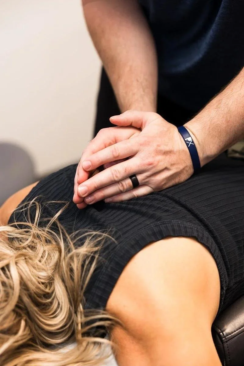 Sports chiropractic adjustment during first visit consultation at Smith Elite in Liberty MO. Smith Elite Family Chiropractic, 527 N State Rte 291 Suite B, Liberty, MO 64068.