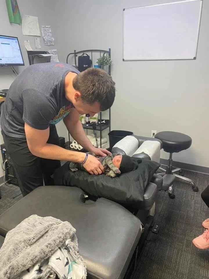 Baby on adjustment table during infant chiropractic care