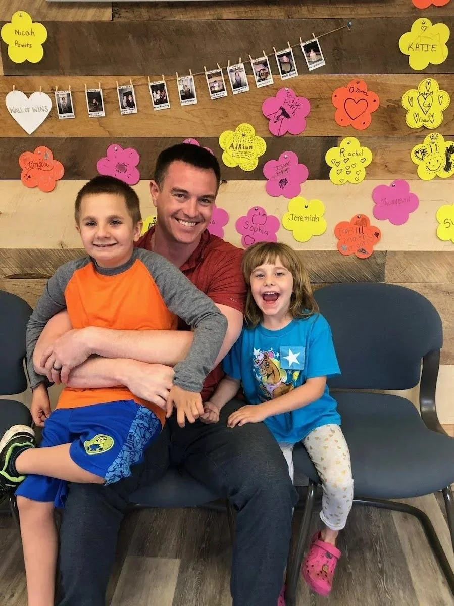 Dr with kids in waiting room representing Northland families