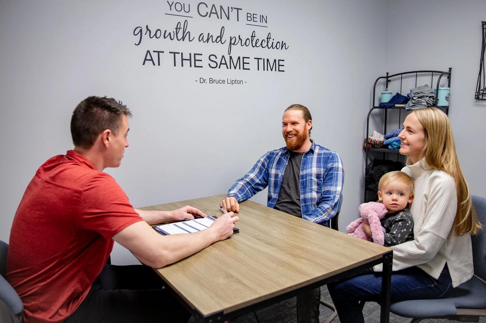 Family chiropractic consultation with Dr Garrett Smith and toddler in Liberty MO