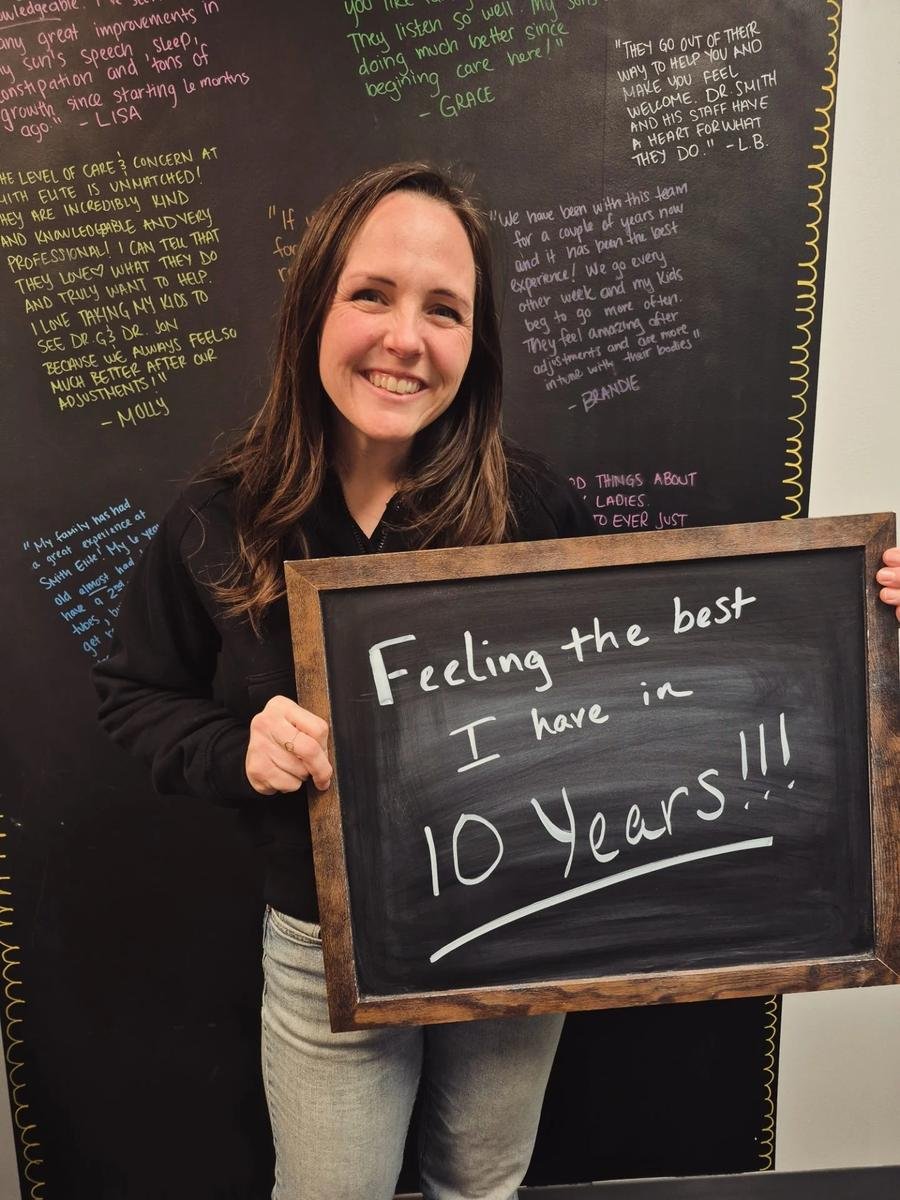 Woman holding chalkboard about feeling the best in 10 years after neurological scan care in Liberty MO