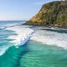 Ocean waves near a rocky headland typical of Queensland's Gold Coast but is actually Burleigh Beach headland near Palm Beach