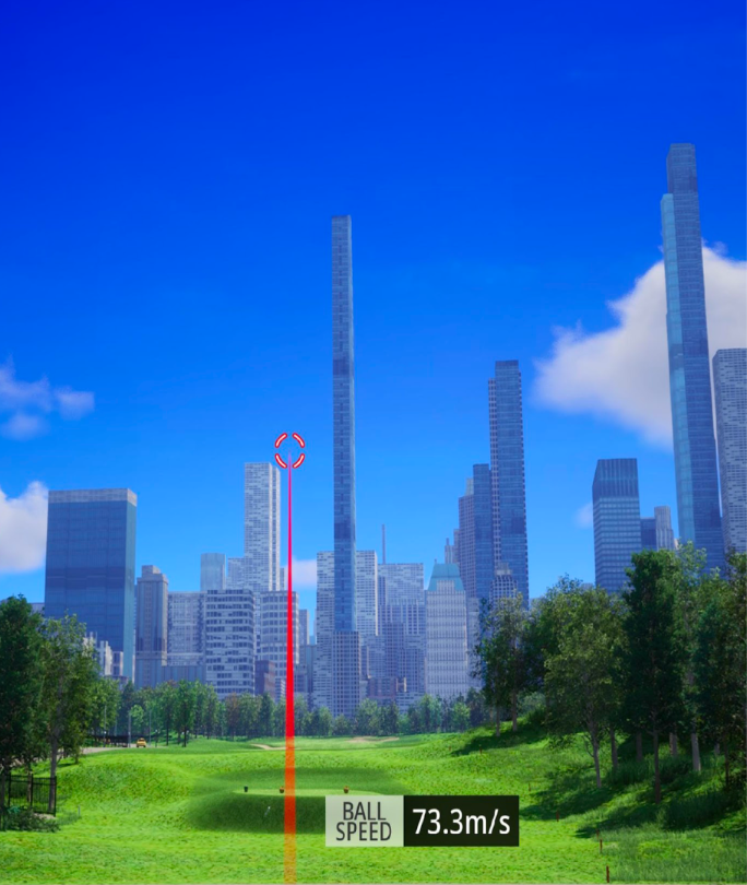 A golf ball in midair with a red trajectory line aiming toward a tall skyscraper in a city skyline, with a ball speed of 73.3 meters per second displayed at the bottom.