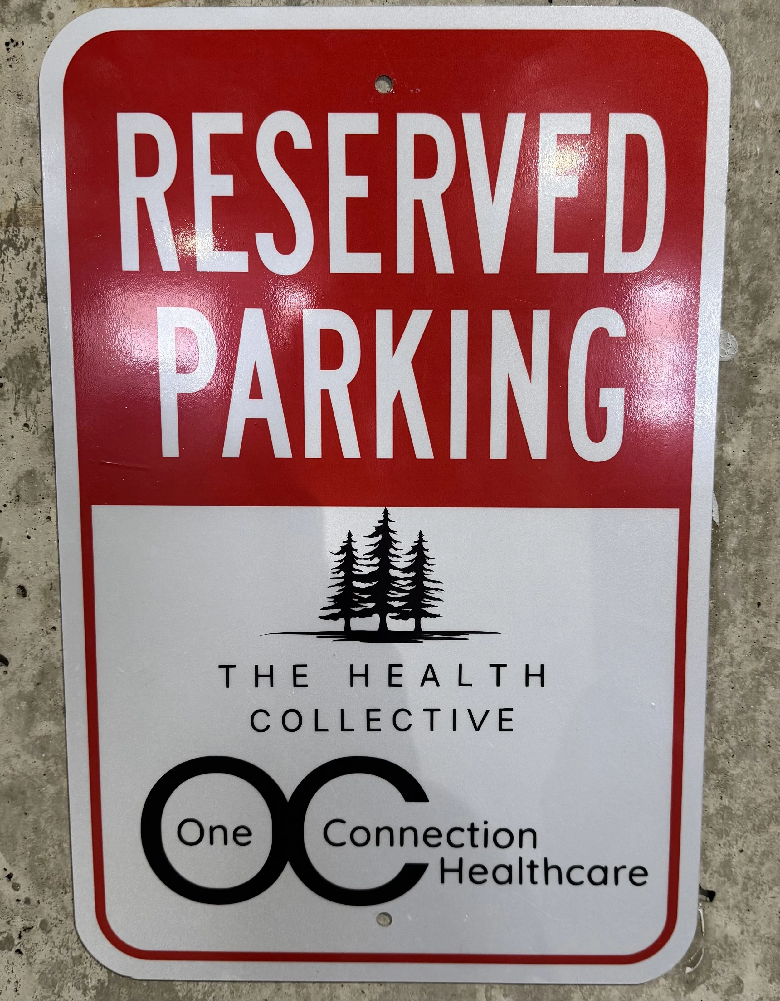 parking placard reads "reserved parking. The health collective. One connection healthcare)