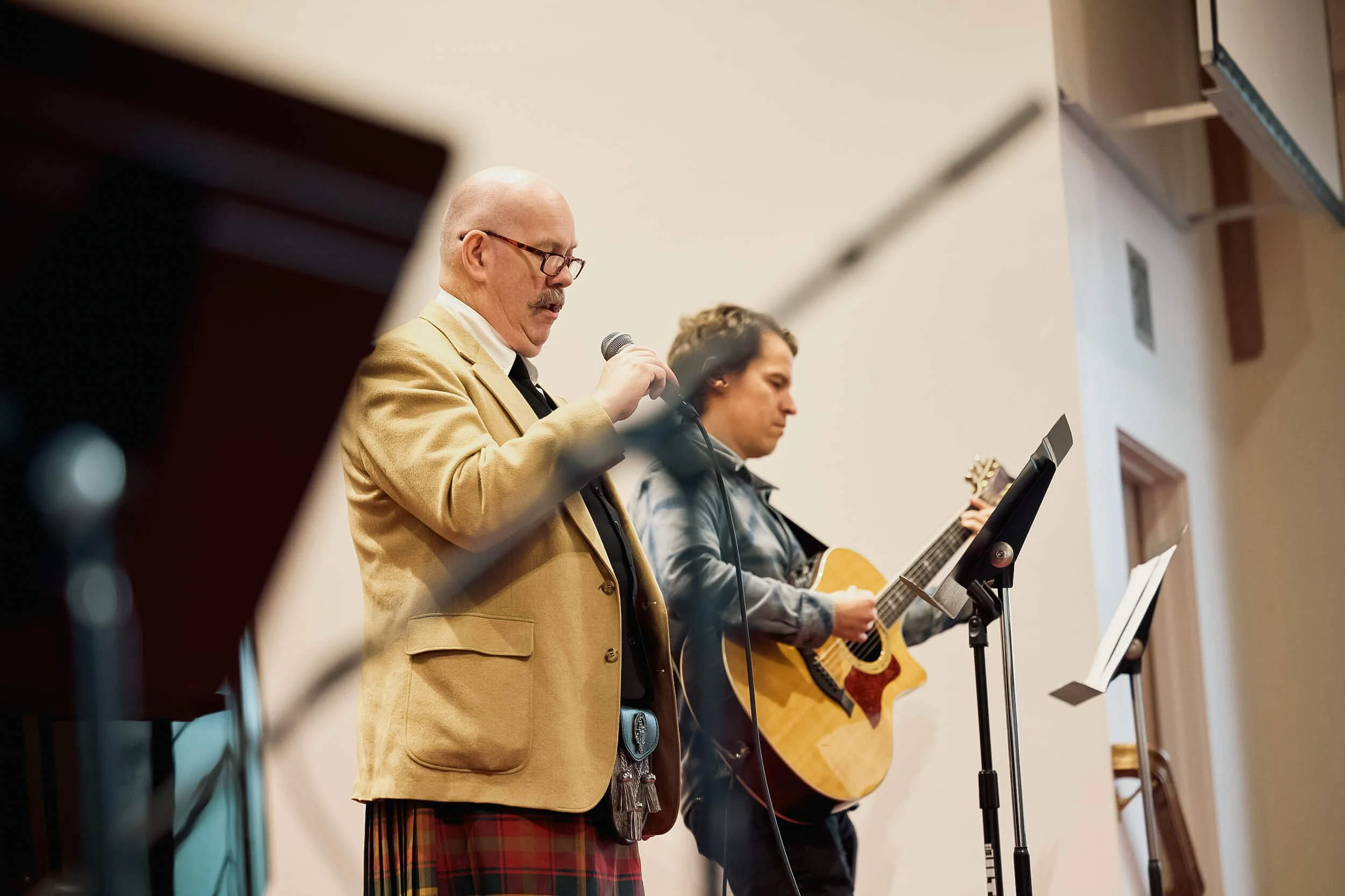 A singer and guitarist lead worship together on stage at Crown Hill Church in Seattle.