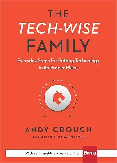 The red cover of the book "The Tech-Wise Family" with a tech dial with an imprint of a house angled toward partially on.
