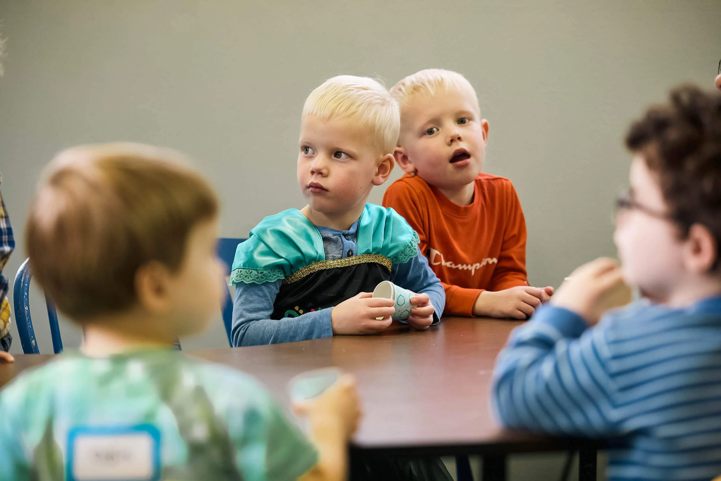 Four preschool children sit together at a table during Sunday school in Sunday School program at Crown Hill Church.