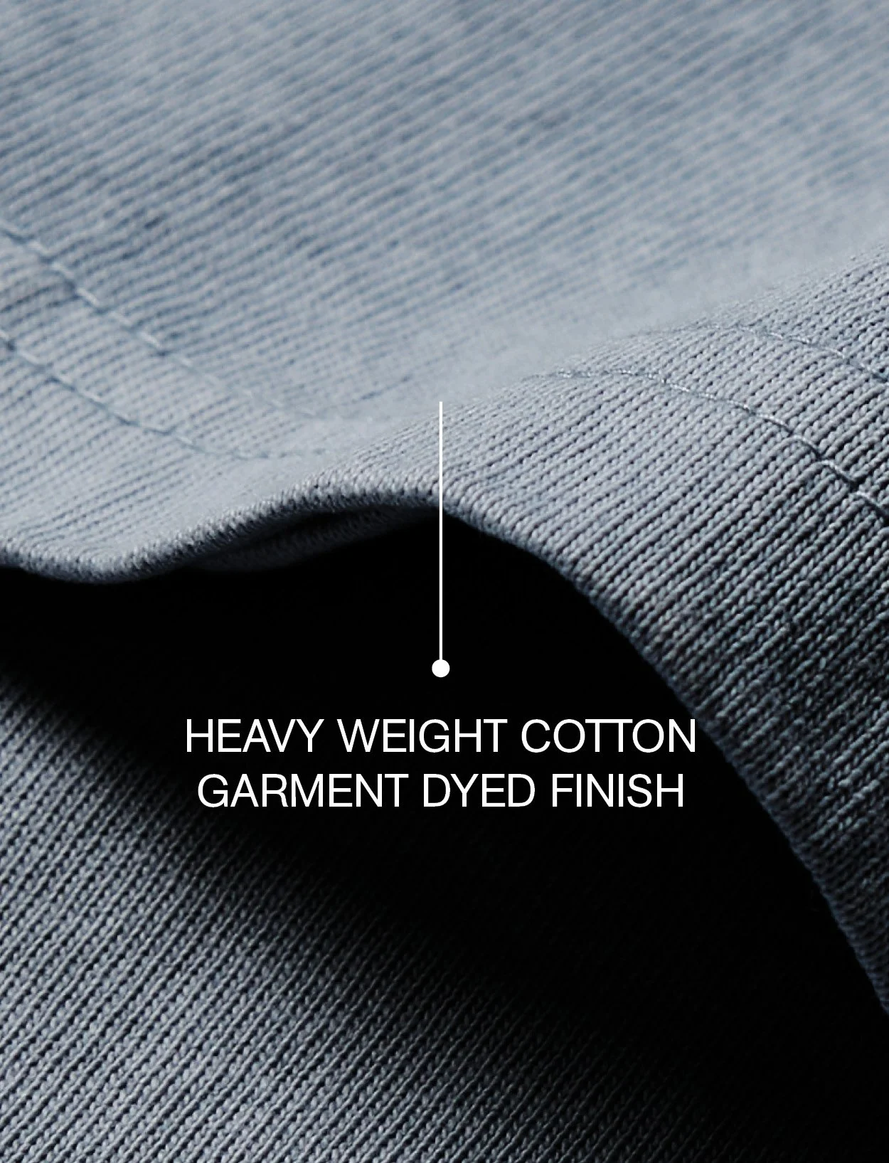Close-up of a light grey cotton fabric with heavy weight, dyed finish, showing detailed texture and stitching.