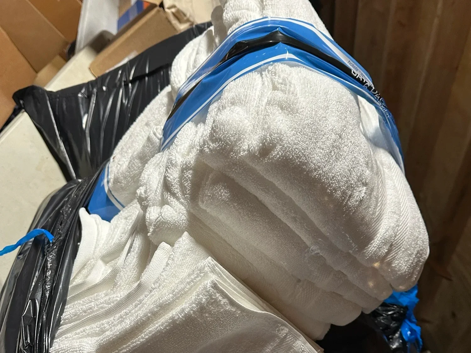 Stack of folded white towels bundled together as part of donated supplies.
