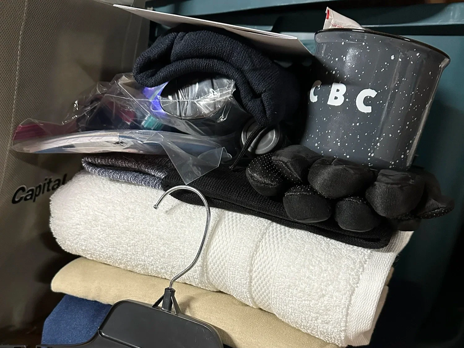 Care package containing towels, gloves, toiletries, and supplies prepared for community outreach.