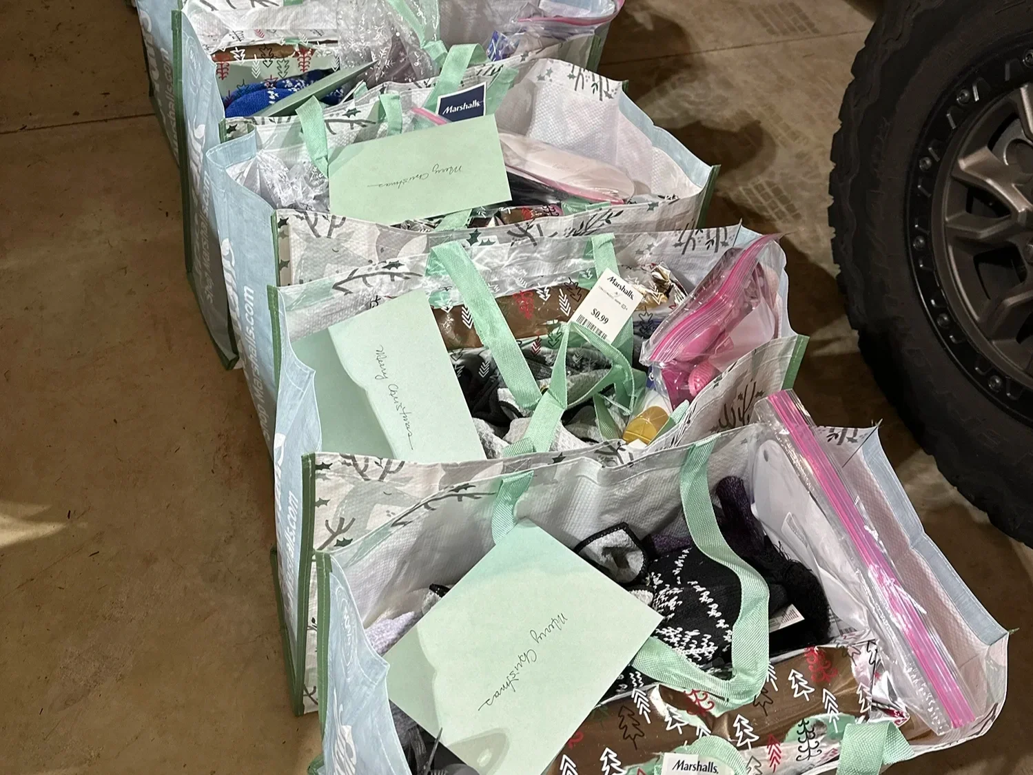 Reusable bags filled with labeled care packages and supplies prepared for community distribution.