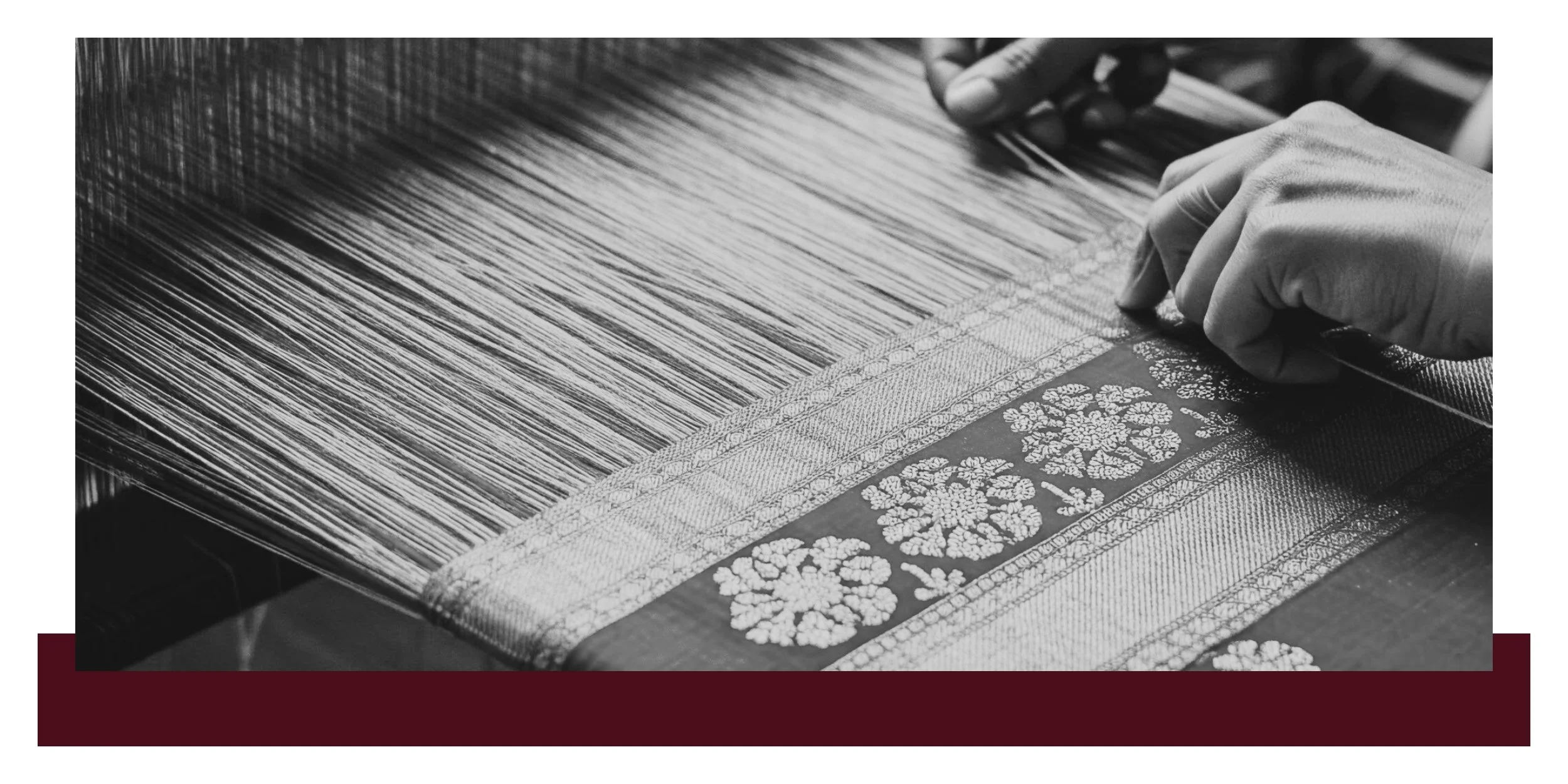 Hands using a tool to apply a patterned surface on a wooden board, with fine grains and stenciled floral motifs in a monochrome close-up.