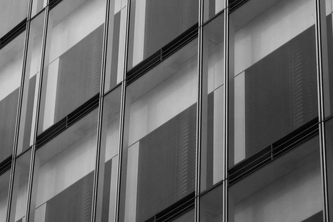 Close-up of modern building windows representing PDK Construction's rigorous quality control standards.