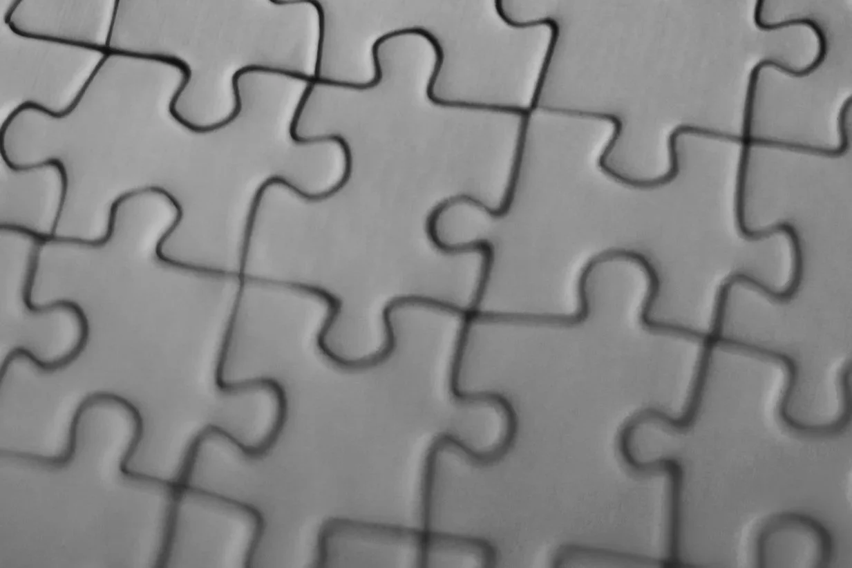 Close-up of interlocking puzzle pieces representing buildability assessment in commercial construction.