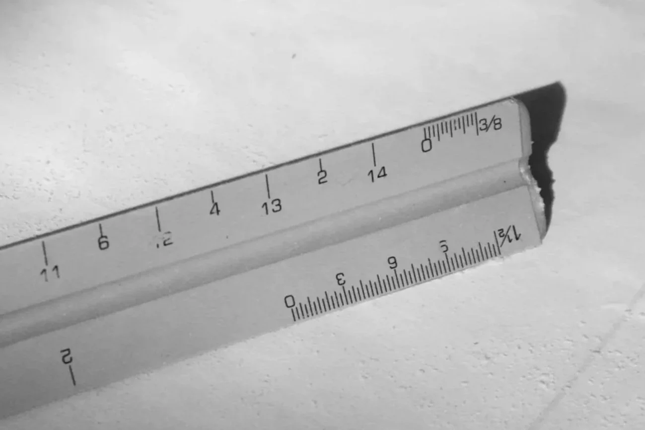 Detailed view of a ruler used for construction estimating and value engineering services.