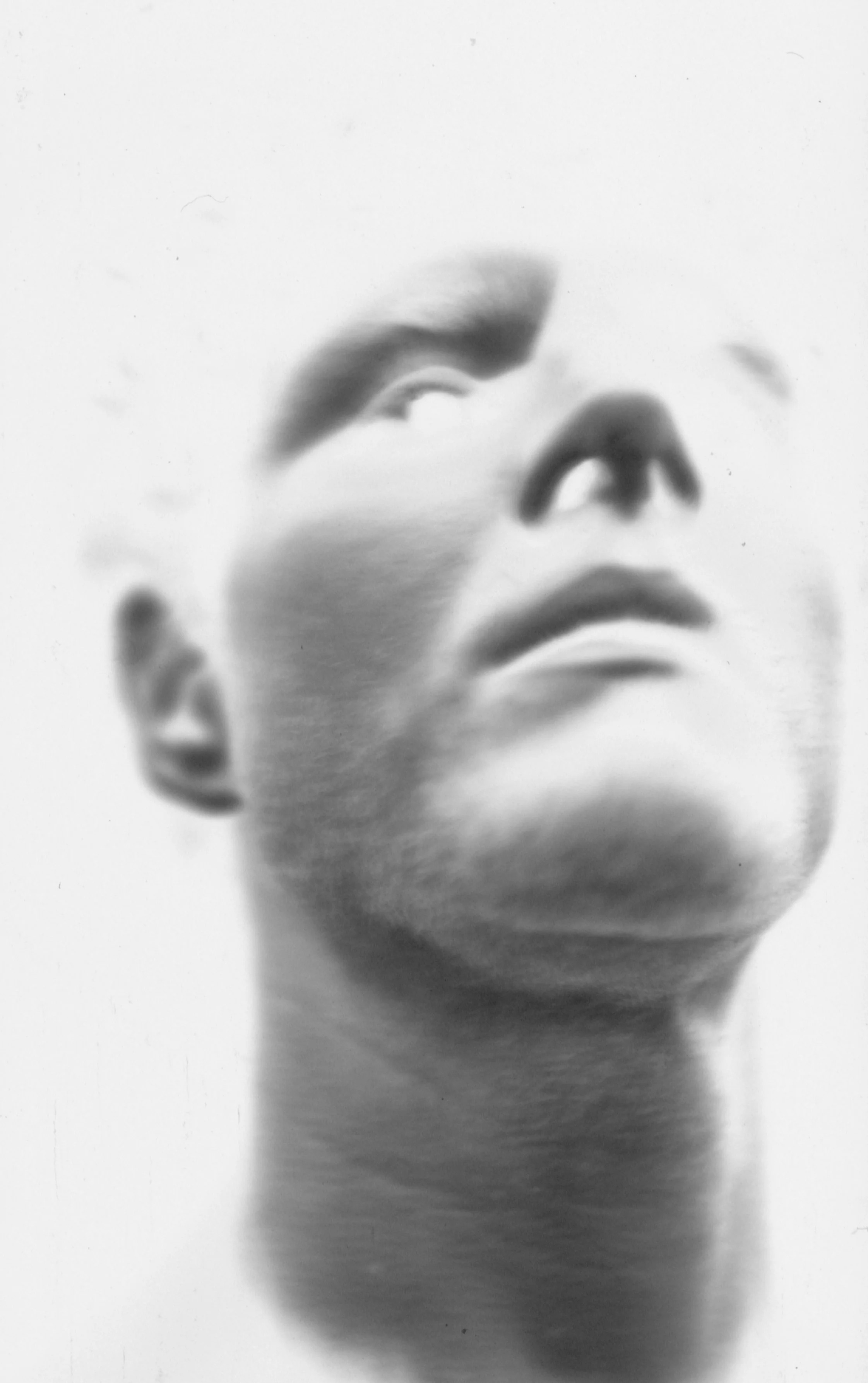 Black and white close-up of a face, showing only the nose, lips, and part of the cheek, with a soft focus effect.
