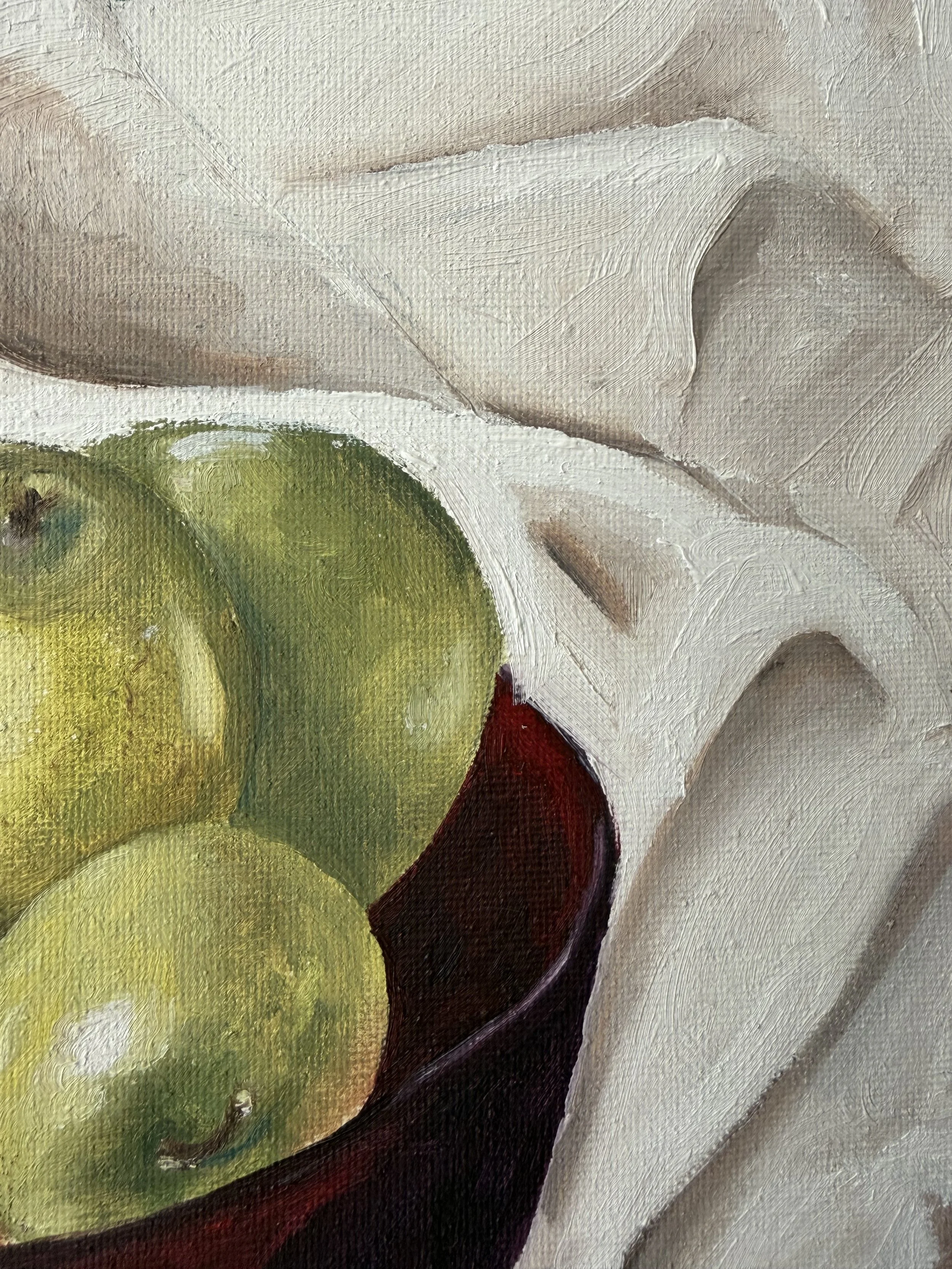 Close-up of a textured painting featuring abstract shapes and colors, including green, white, black, and brown.