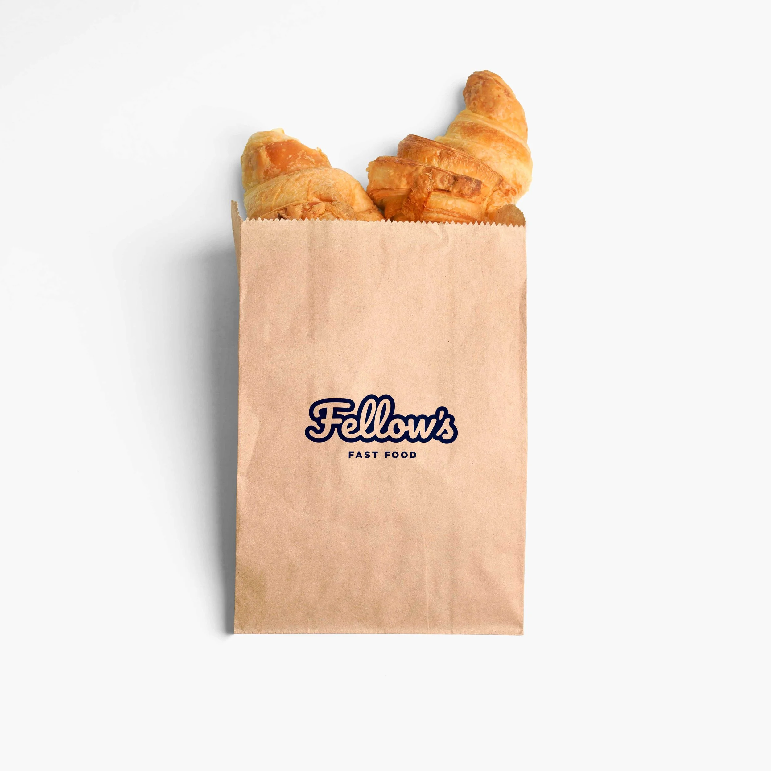 Dos croissants en una bolsa de papel con el logo que dice 'Fellow's Fast Food'