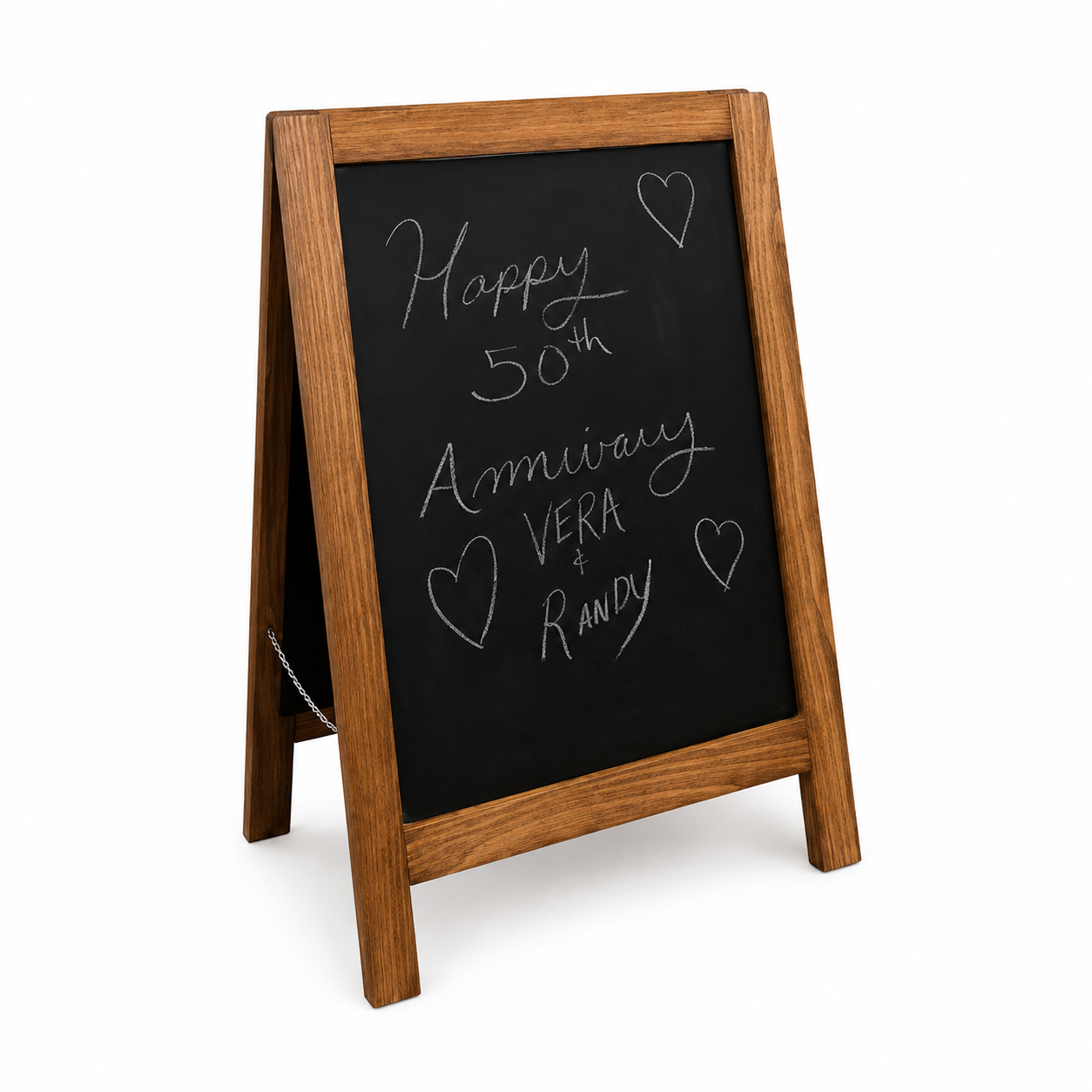 Wood-framed chalkboard sign with handwritten message celebrating a 50th wedding anniversary for Vera and Randy, decorated with hearts.
