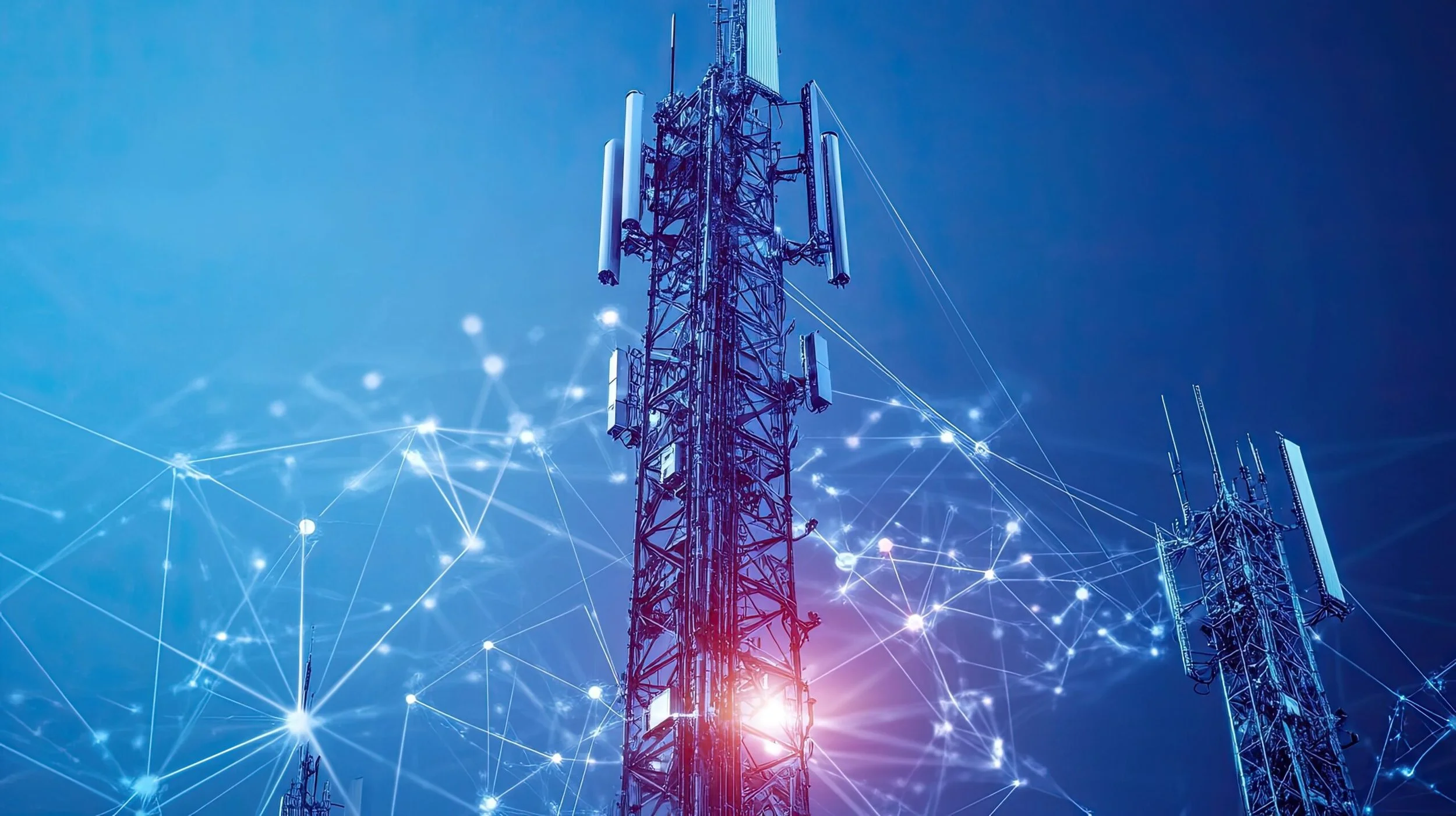 Multiple telecommunications towers with digital network overlays and a bright light at the base of one tower, representing wireless communication and connectivity.