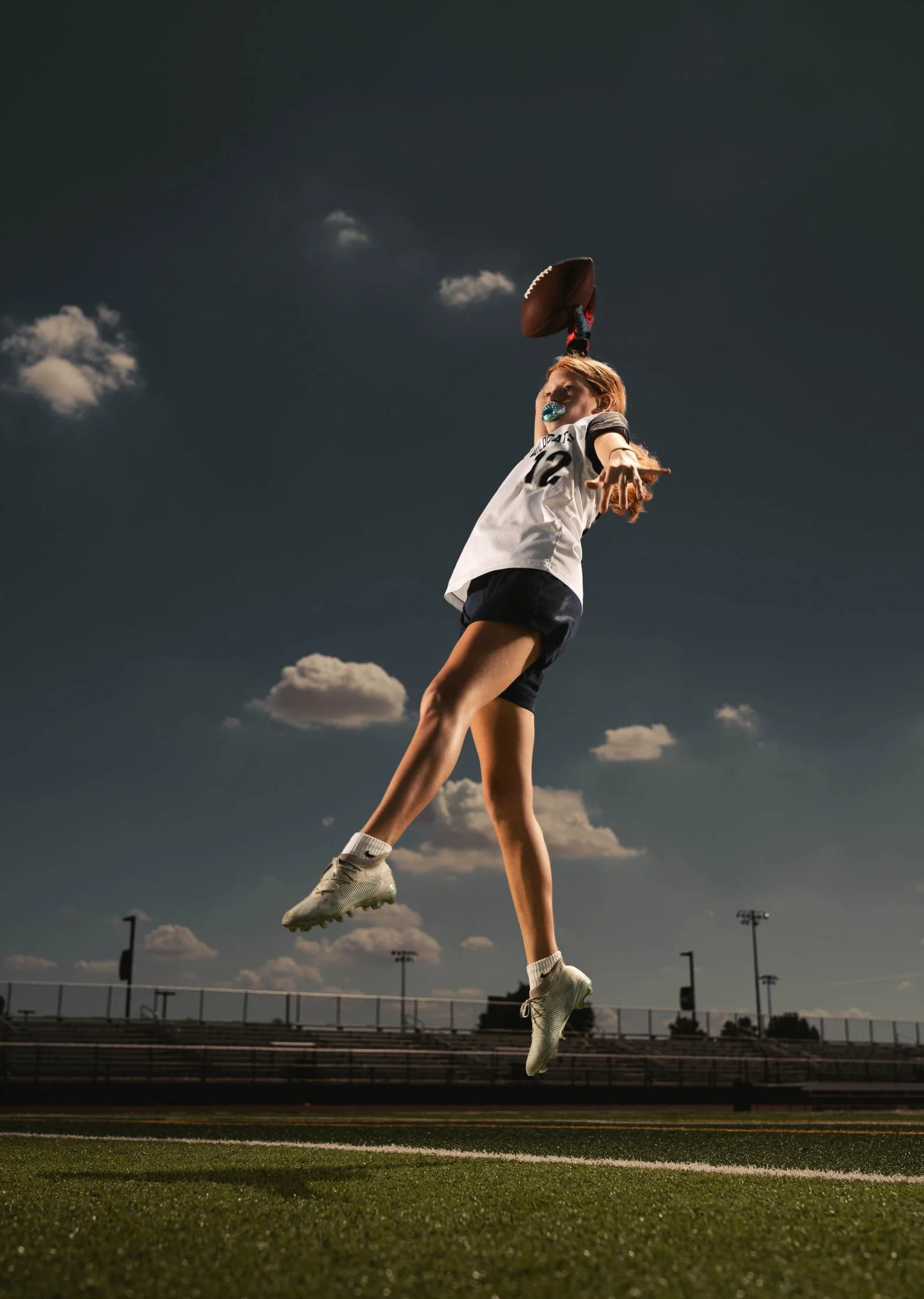High school senior girl catching a football in Phoenix, Arizona