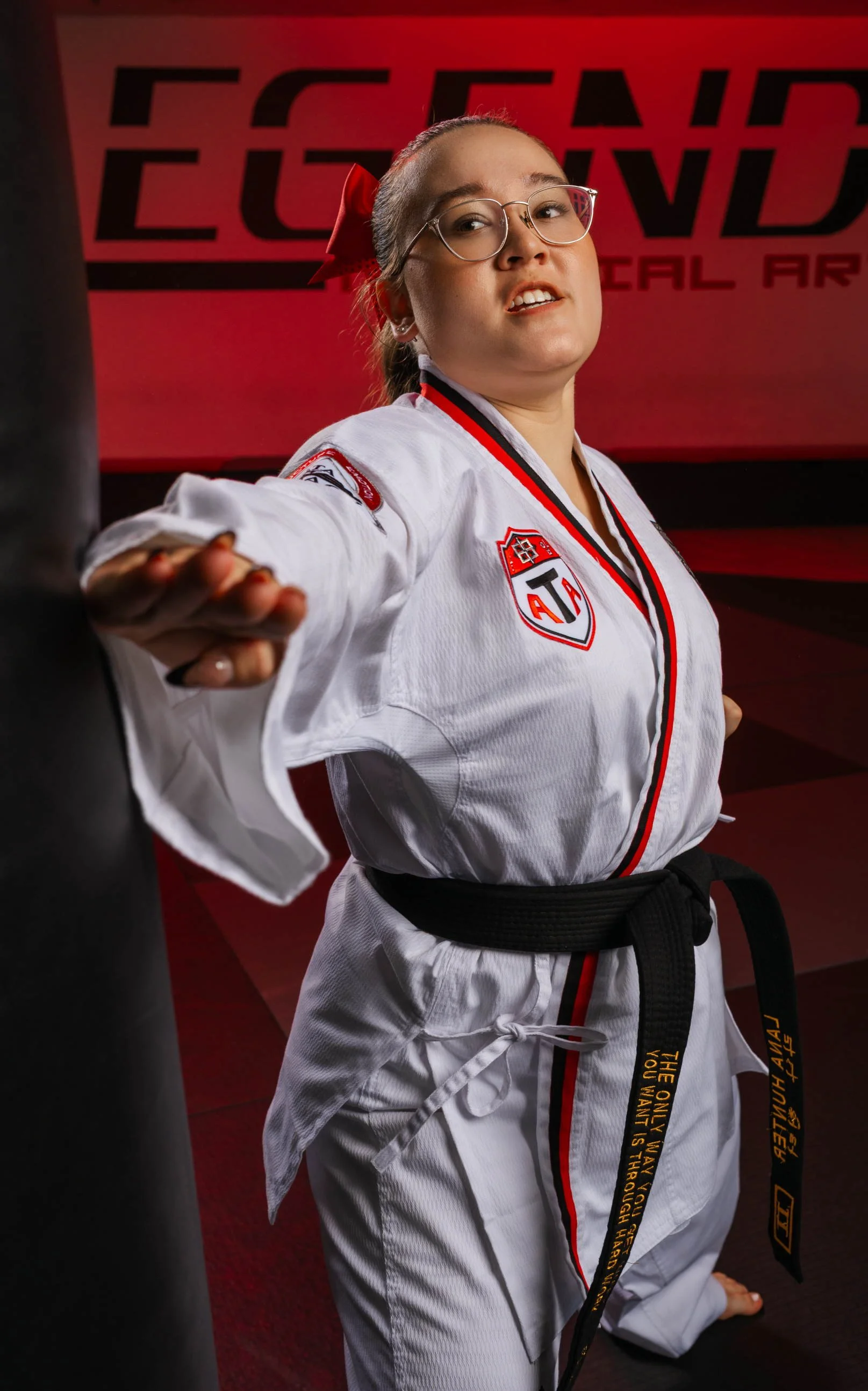 Senior girl in Phoenix Arizona hitting a body bad, practicing her taekwondo