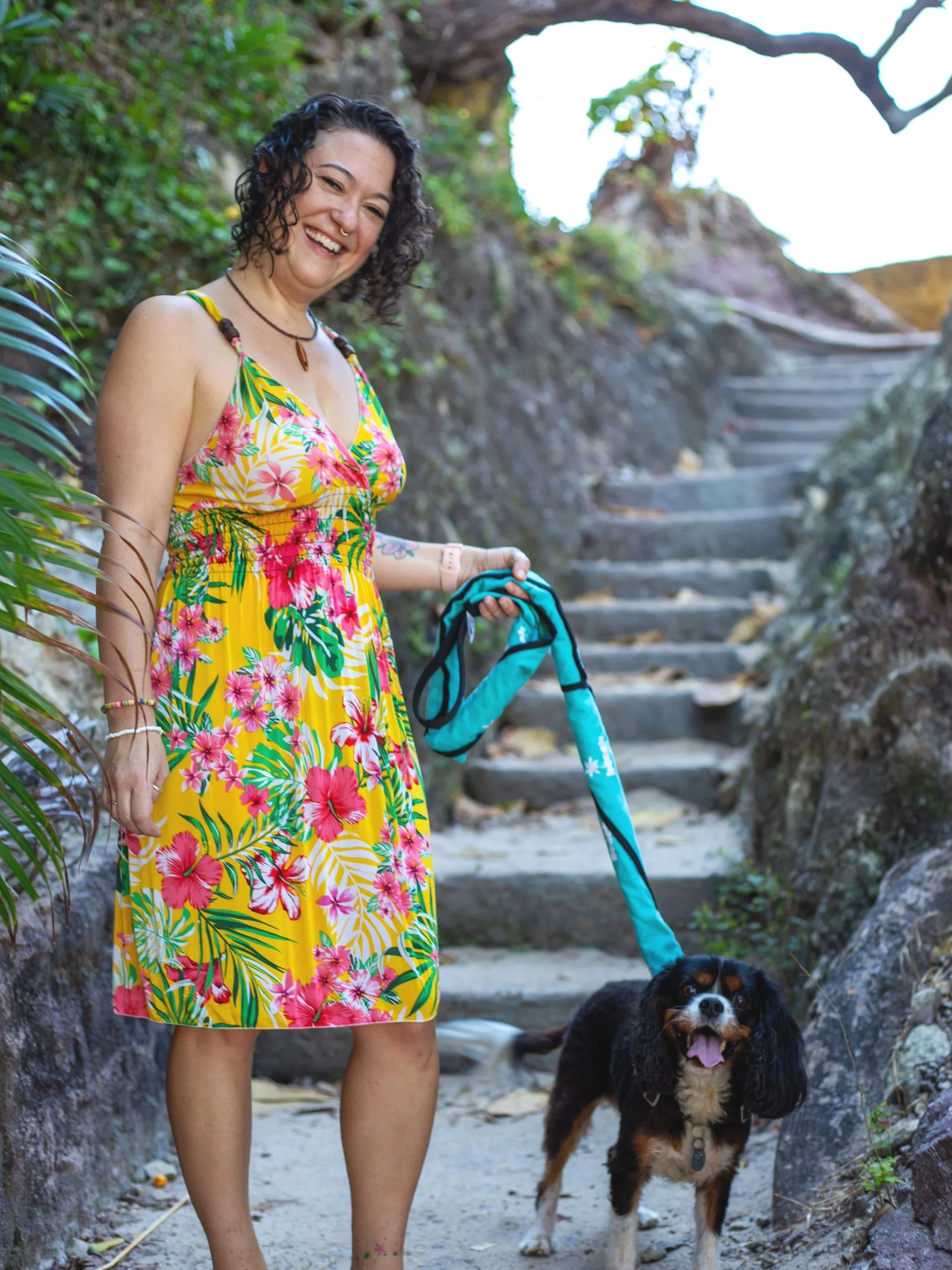 Kayla with her dog Tripp on a stone stairway