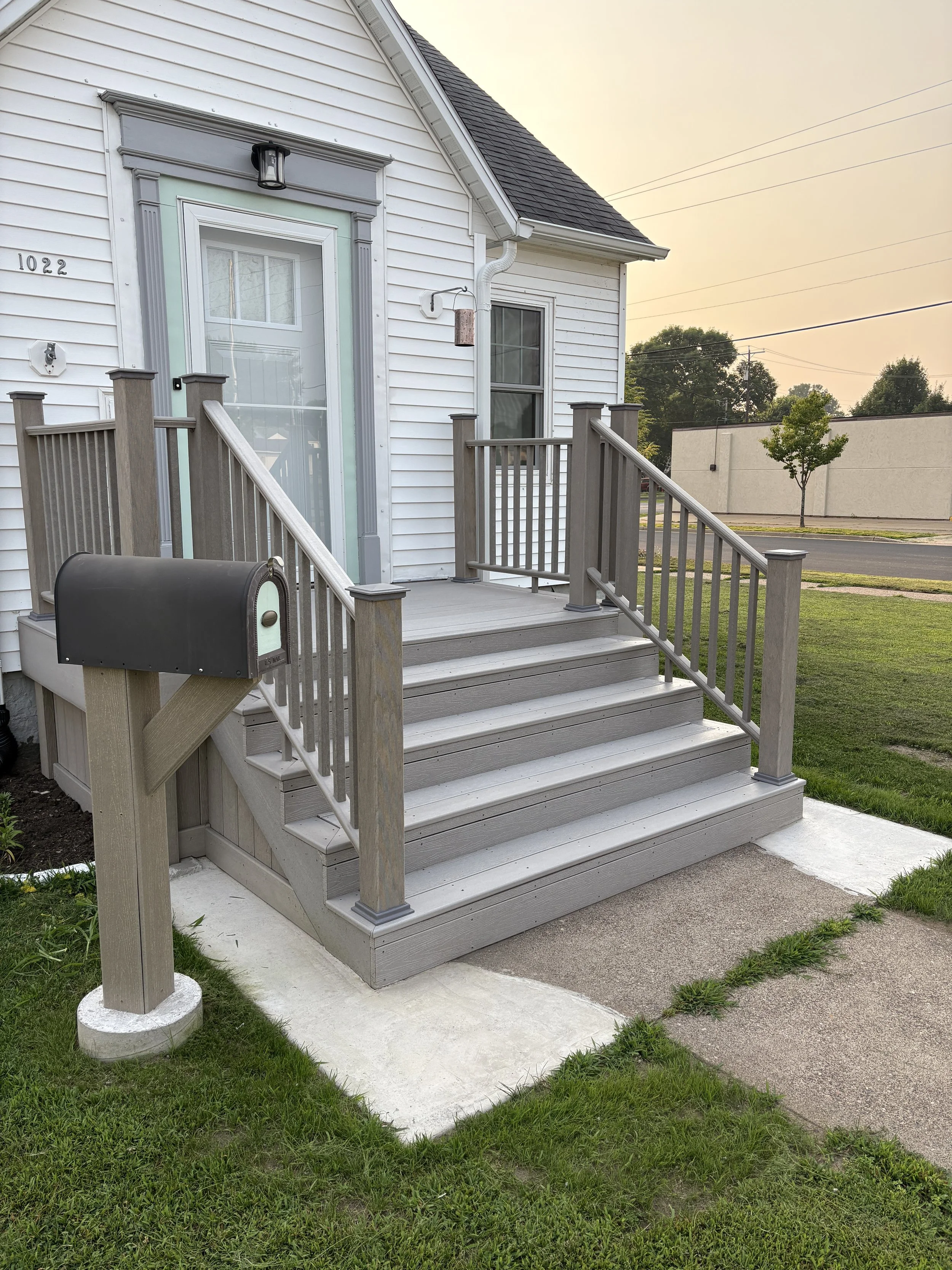 After porch renovation featuring new composite steps and railing installed by Cornerstone Home Improvement in Central Wisconsin.