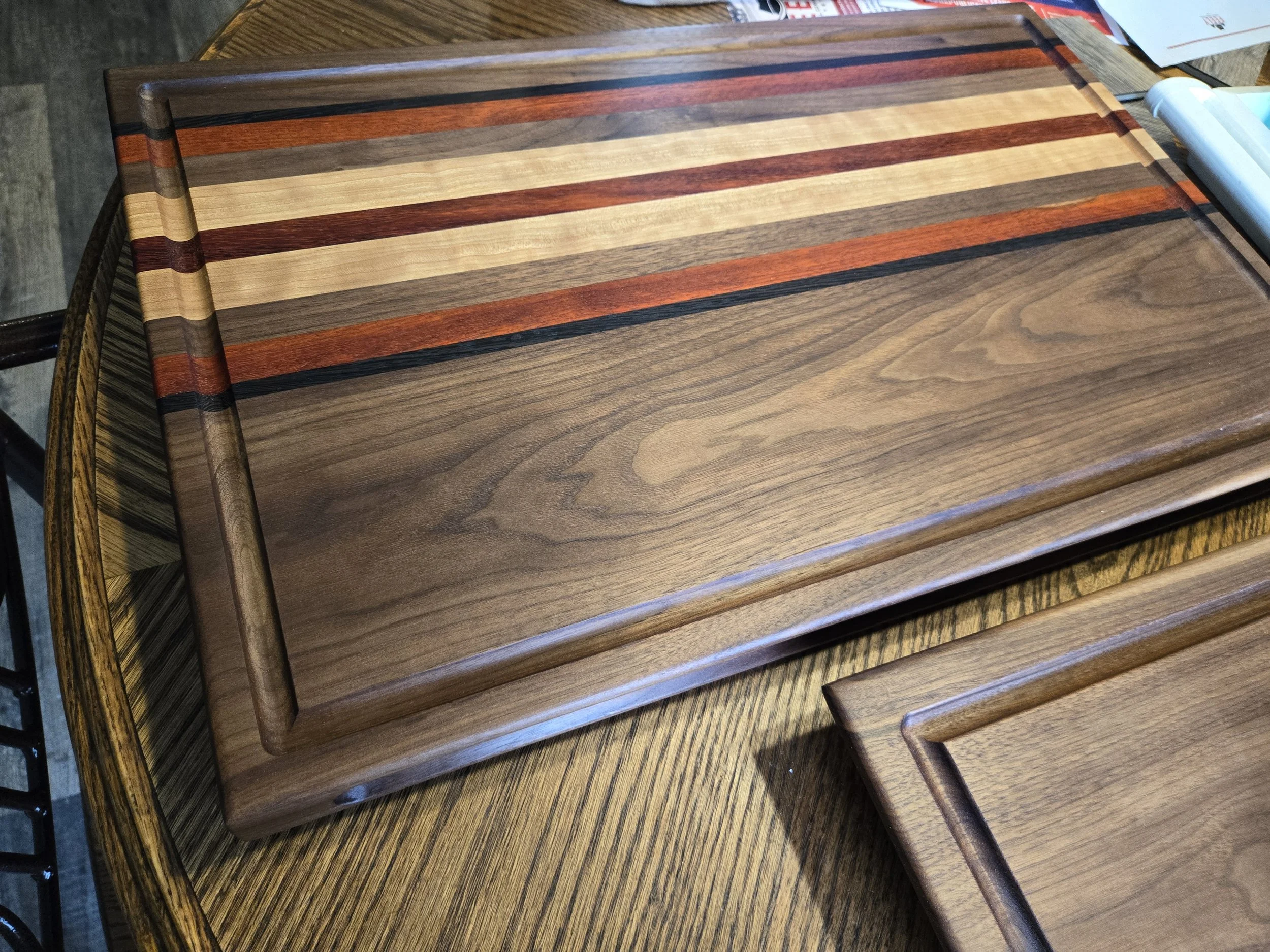 Custom cutting boards with various species of hard woods and all sealed with all-natural board butter. 