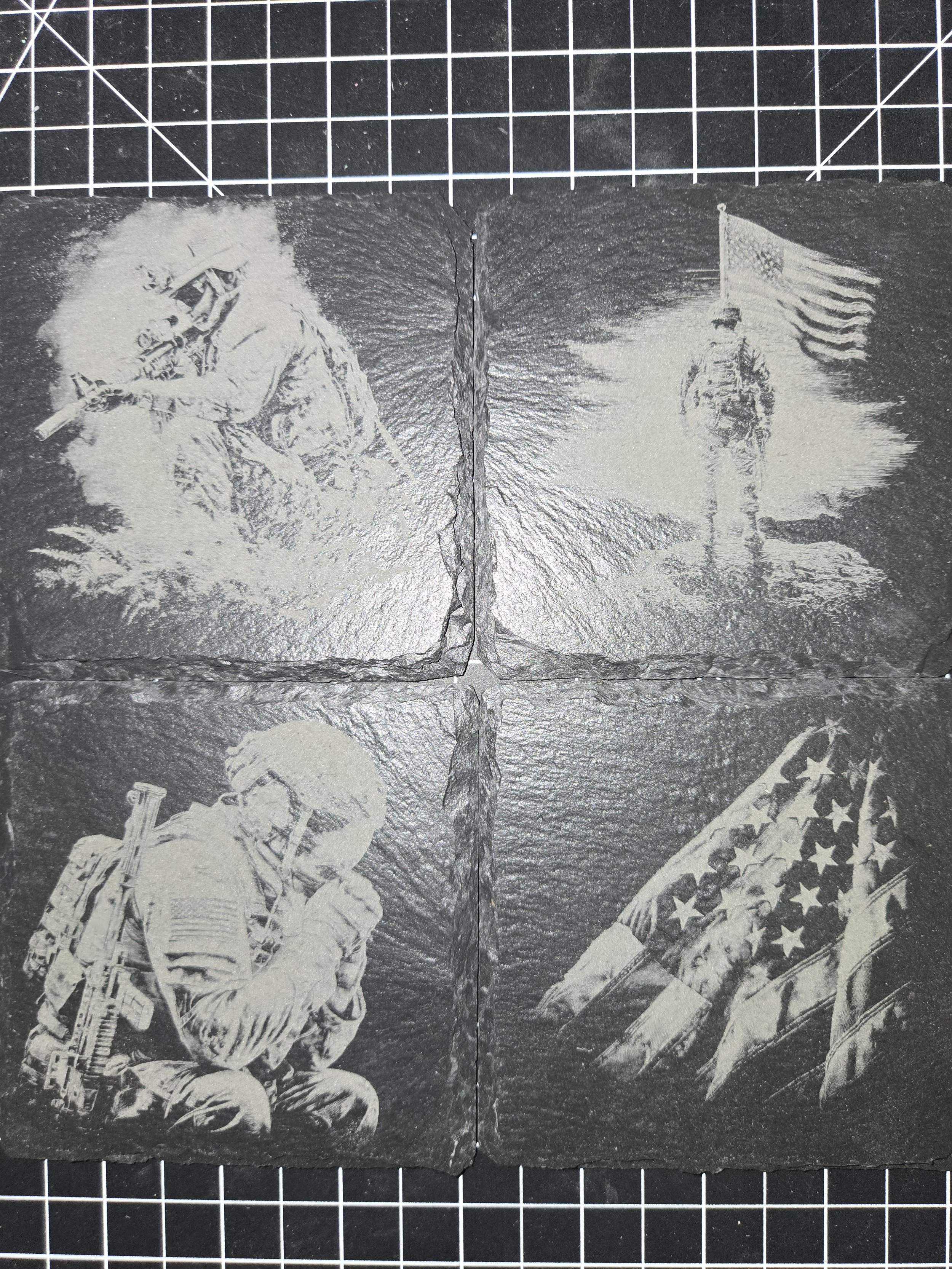 Four black and white engraved images of soldiers and American flags on slate tiles.