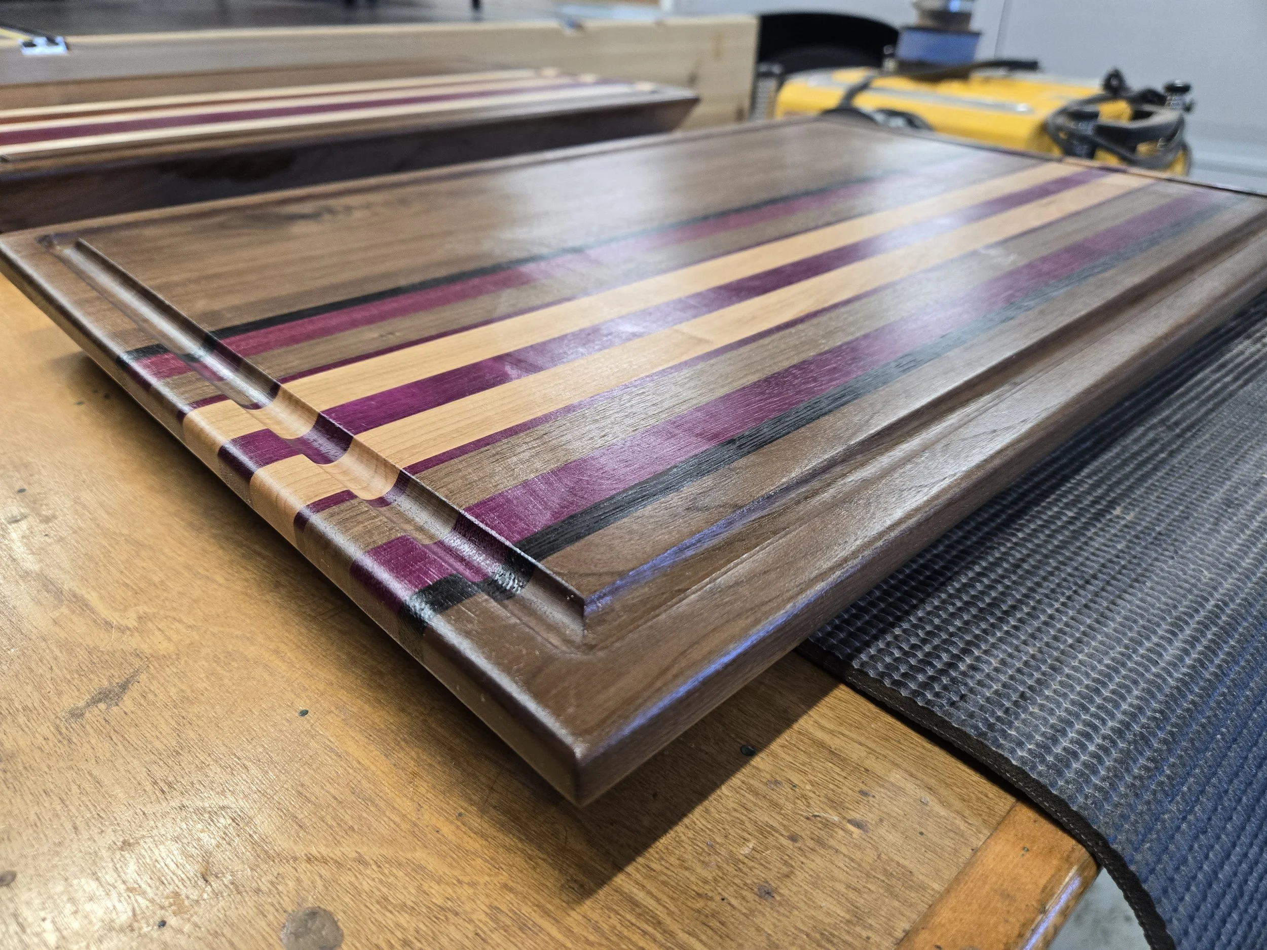 Custom cutting boards with various species of hard woods and all sealed with all-natural board butter. 