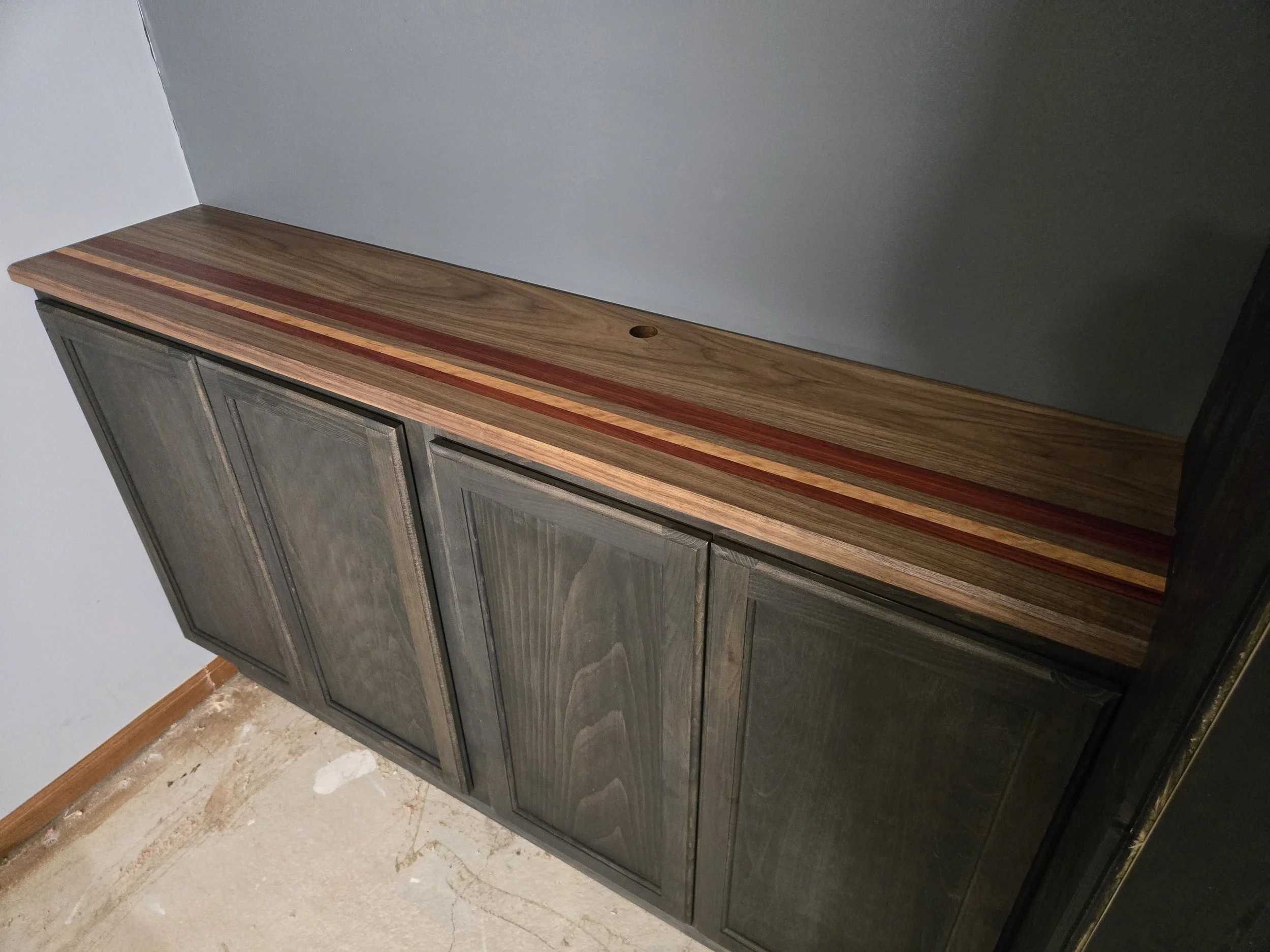Custom built cutting board counter top with walnut, paduk and cherry accents