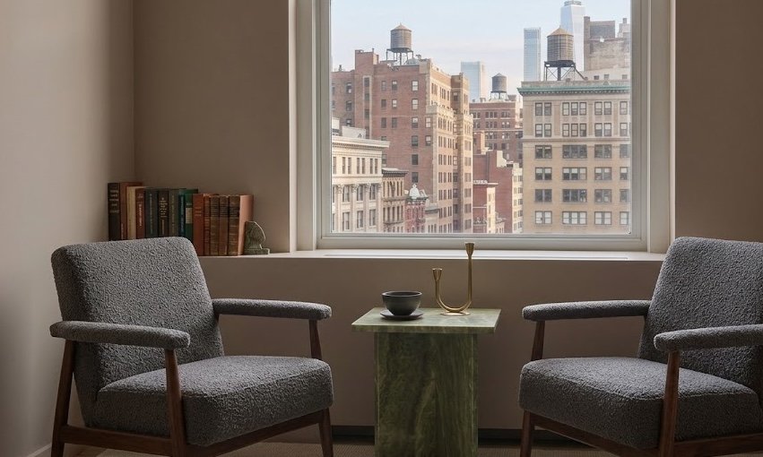 Professional, calm therapy office with New York City views, designed for deep individual and couples work at Knots Counseling.