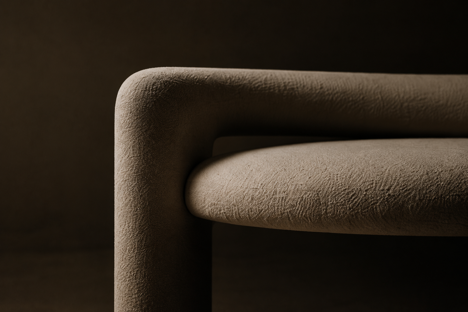 Close-up of a modern beige upholstered armchair with textured fabric, set against a dark background.