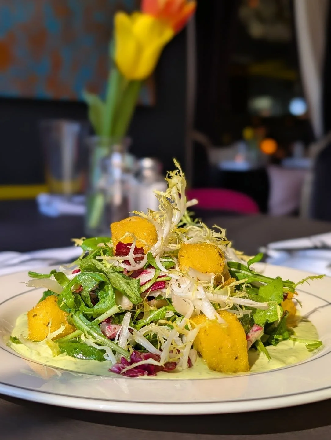 Insalata Tricolore &bull; tonnato verde, blonde frisee, radicchio, arugula, white balsamic vinaigrette, polenta croutons 🌱