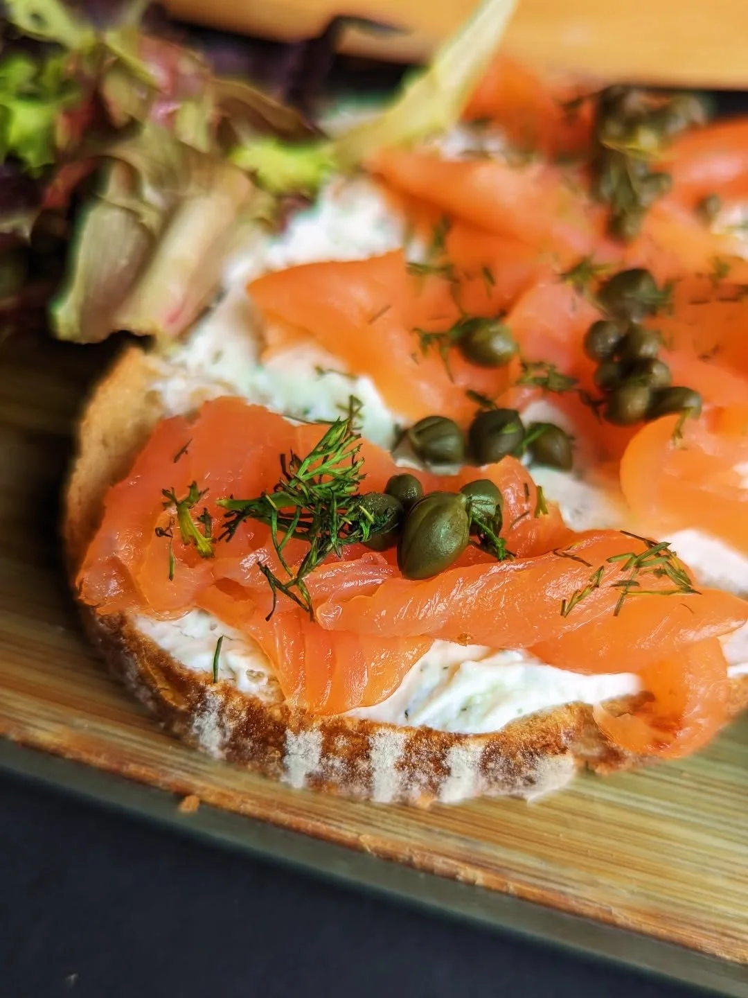 One of our many delicious bruschetta topping options: Smoked Salmon with house boursin, capers, and fresh dill ✨