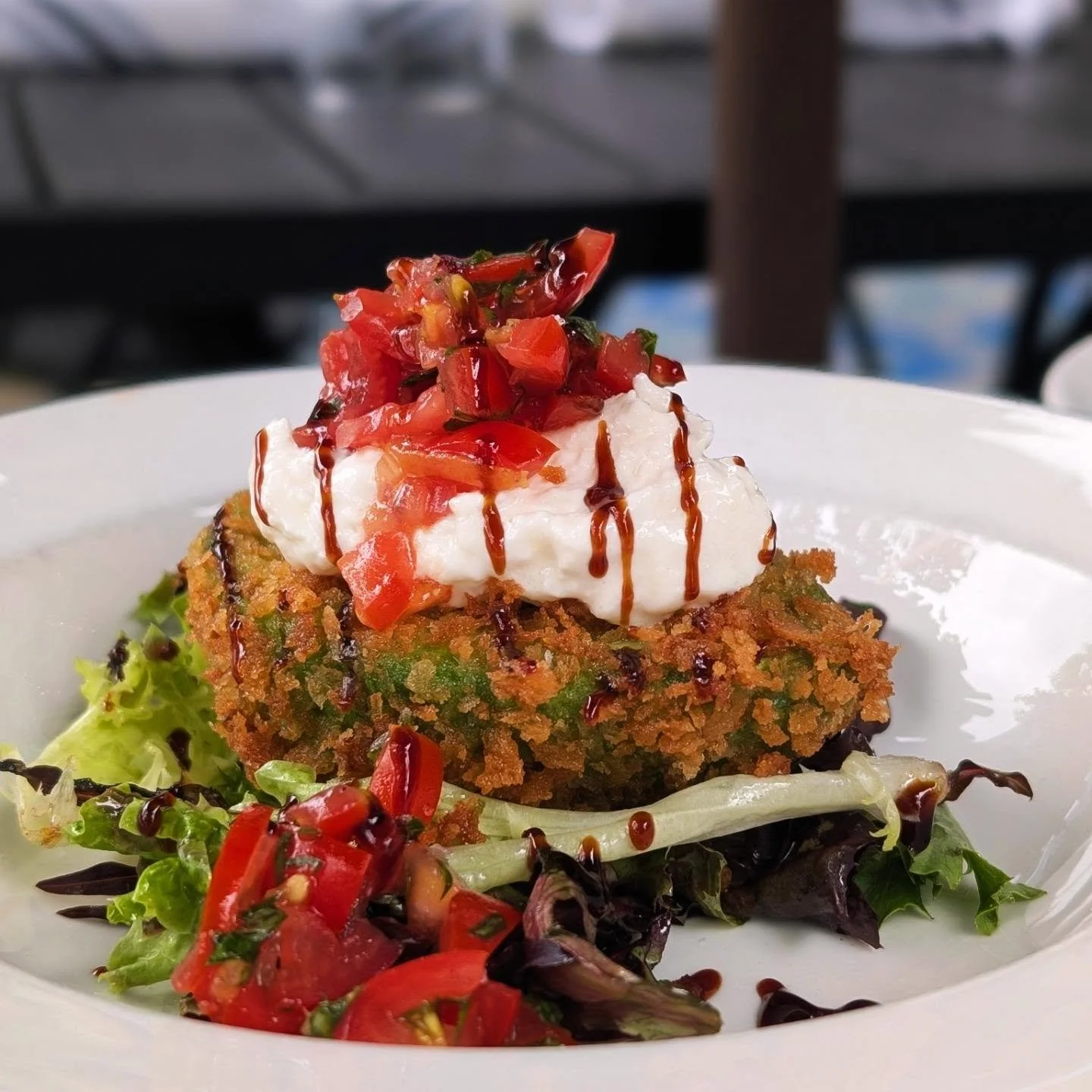 Crispy Stuffed Avocado Caprese 🌱 with juicy tomato, fresh basil, stracciatella, aged balsamic, maldon sea salt