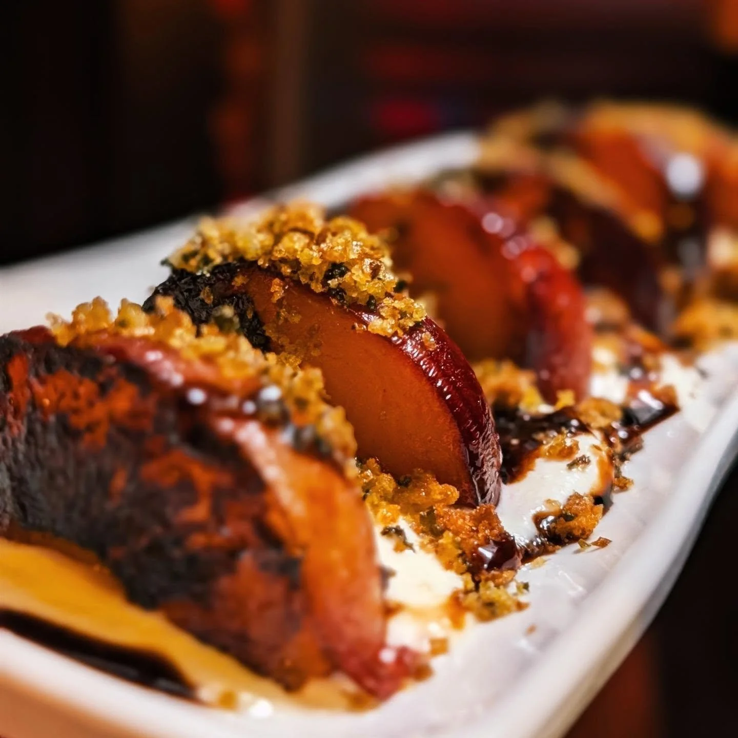 seared &amp; buttered plums, lemon whipped feta, basil breadcrumb, aged balsamic