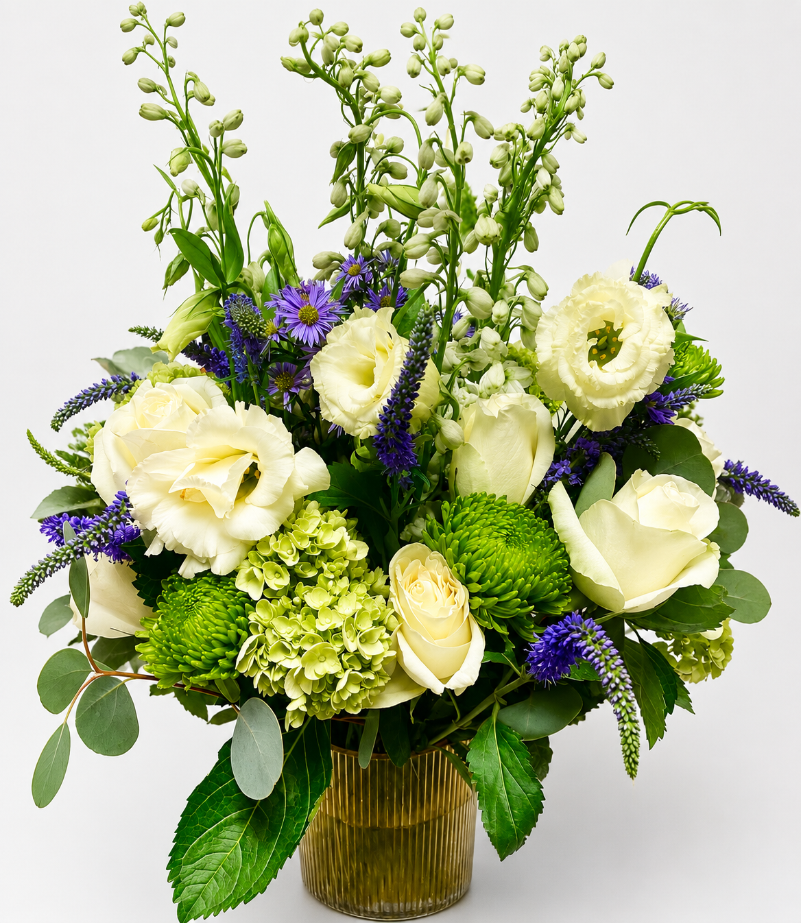 Custom floral arrangement featuring white roses, veronica flowers, green chrysanthemums, and soft seasonal greenery.