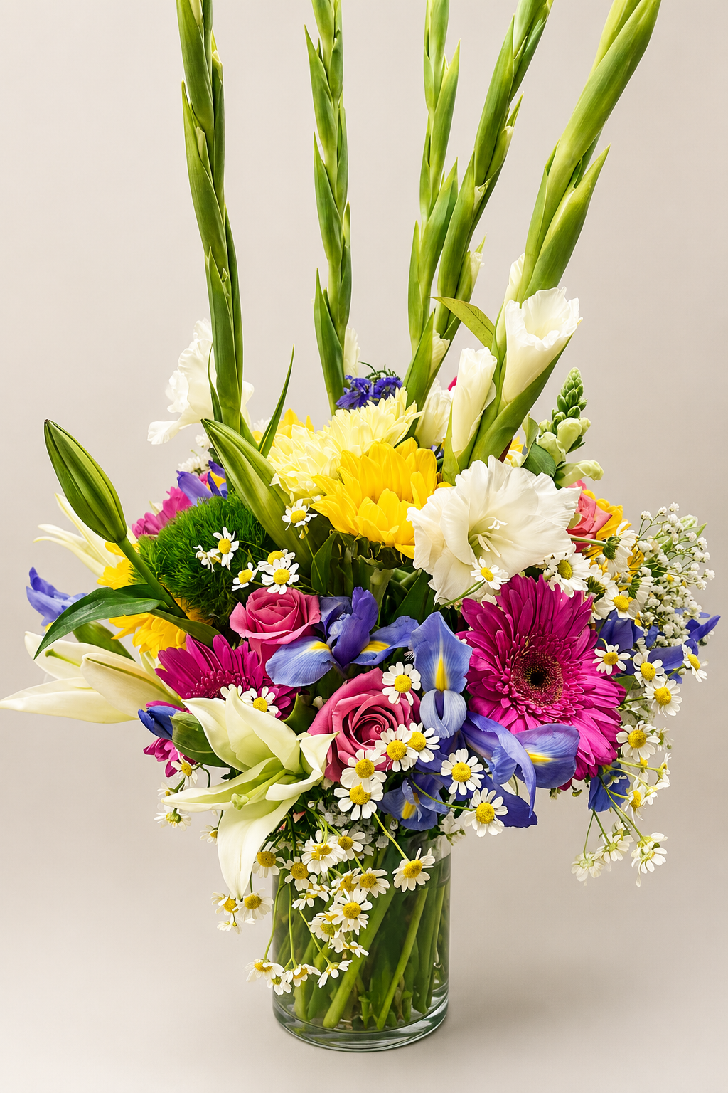 Bright, colorful custom floral arrangement featuring lilies, pink roses, purple iris, gladiolus, and delicate white flowers.
