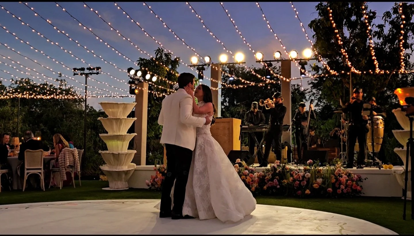 Live wedding band performing at a luxury wedding in Los Cabos at Flora Farms, creating an elegant atmosphere during the couple’s first dance.