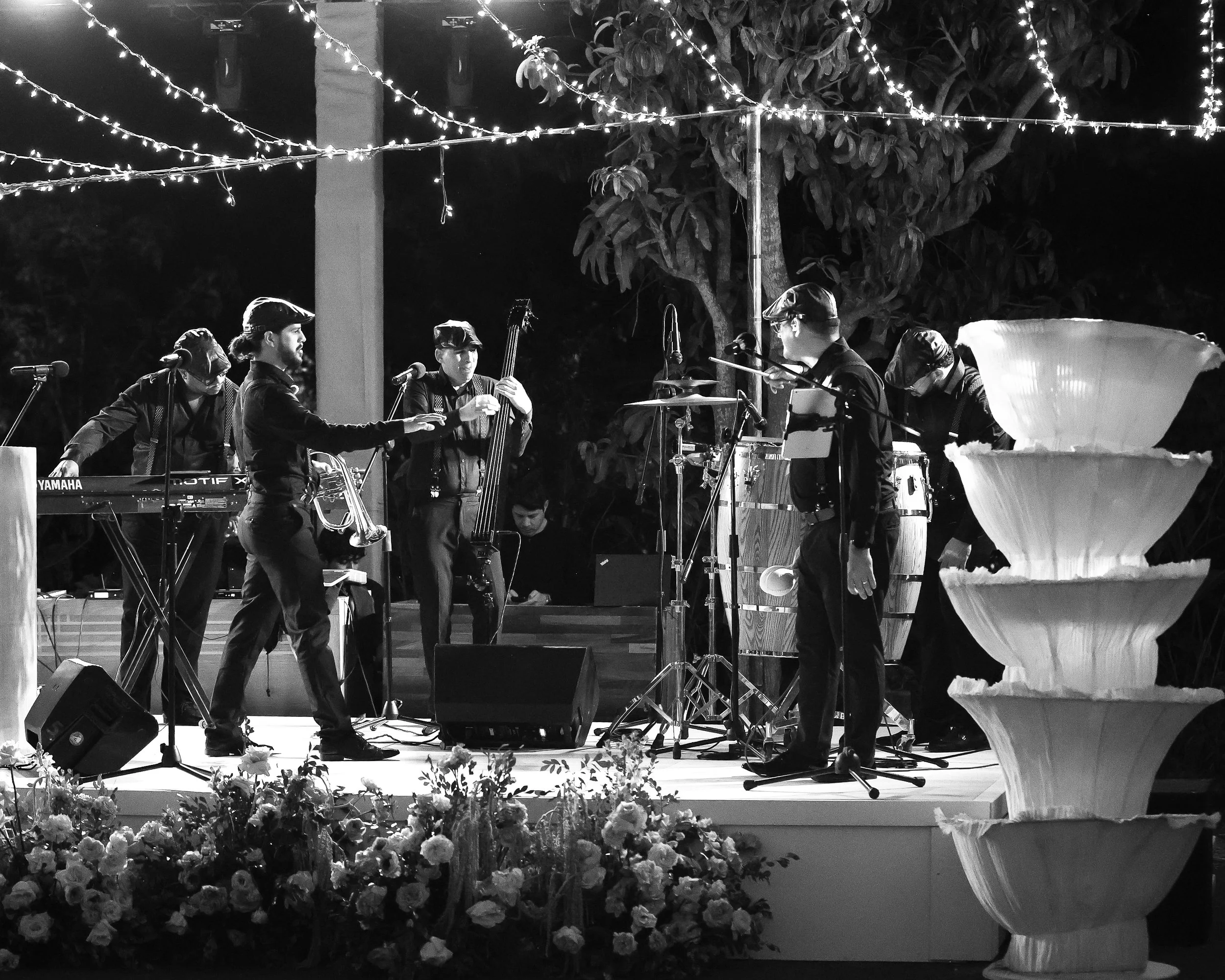 Live wedding band performing during a luxury destination wedding in San José del Cabo, creating a vibrant and elegant atmosphere during an outdoor night reception.