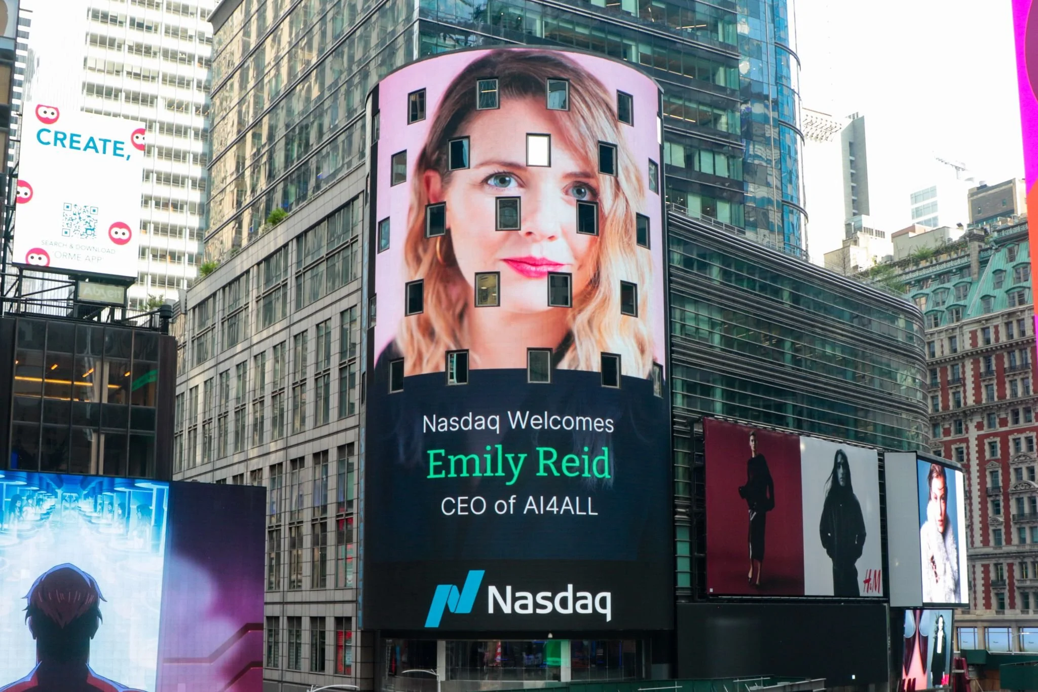Large digital billboard in Times Square featuring a woman's face with blonde hair and blue eyes, with the text 'Nasdaq Welcomes Emily Reid CEO of AI4ALL' and many surrounding advertisements.