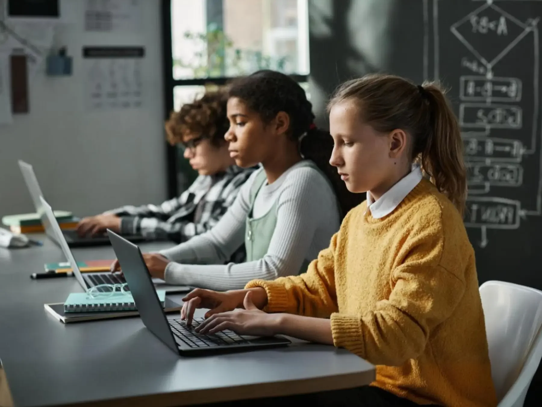 Students learning game development and programming during a hands-on STEM technology class