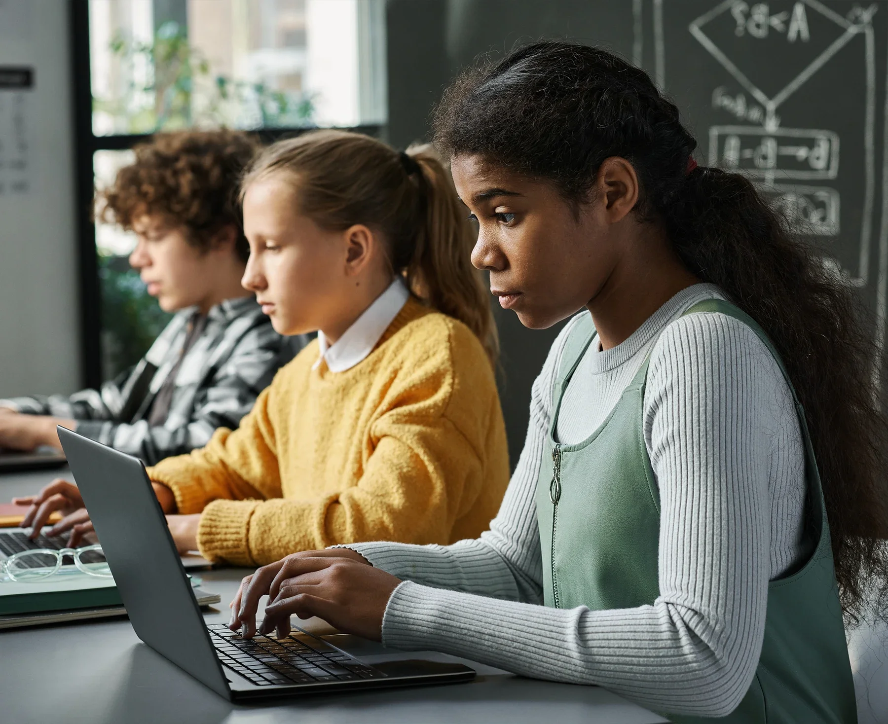 Students learning game development and coding together in a classroom studio environment