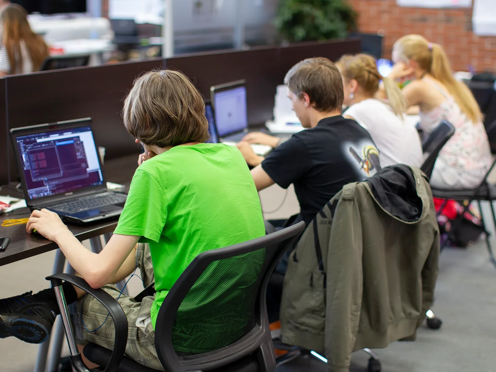 Students working on computers developing digital projects in a collaborative learning space