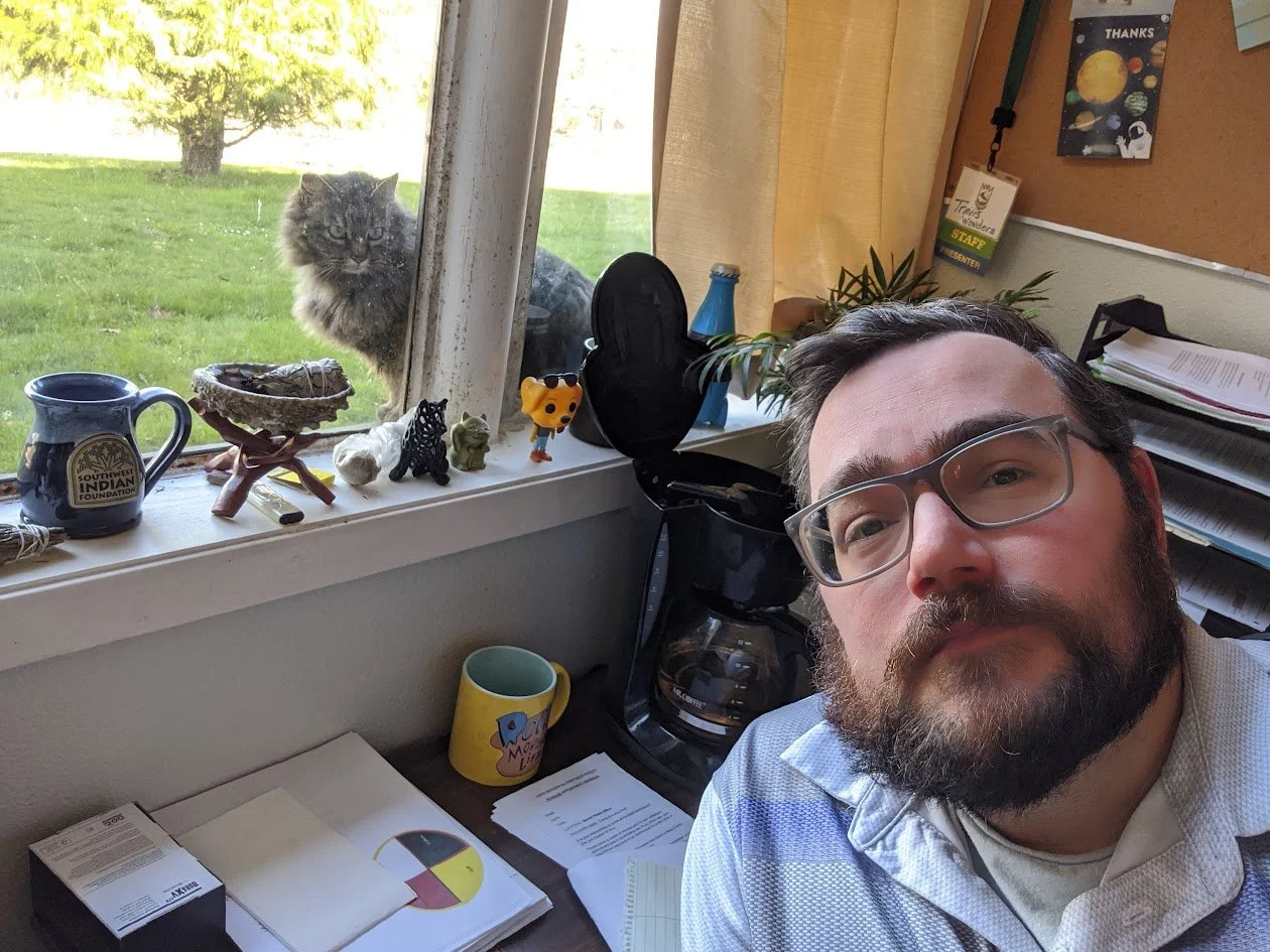 Myself in an office with a cat looking in the window