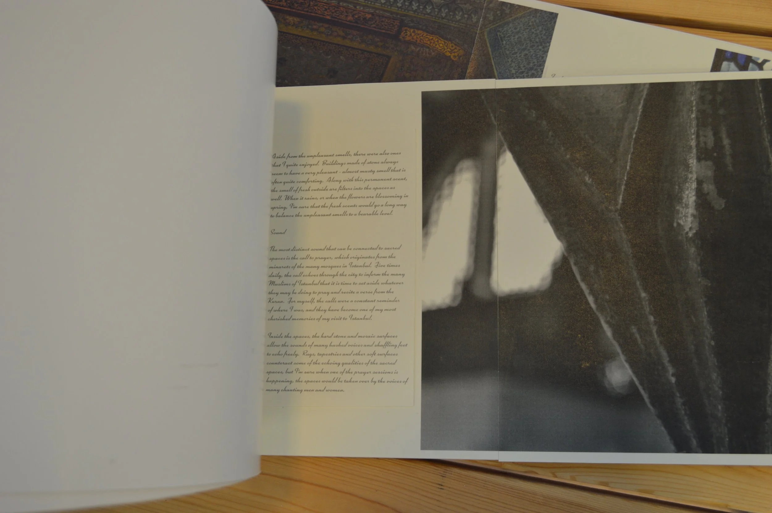 Open book with text on the left page and a dark, marble-like pattern on the right page, resting on a wooden surface.